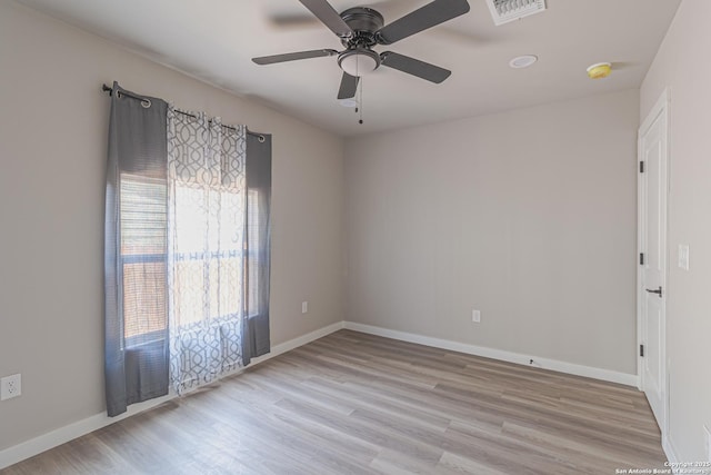 spare room with ceiling fan and light wood-type flooring