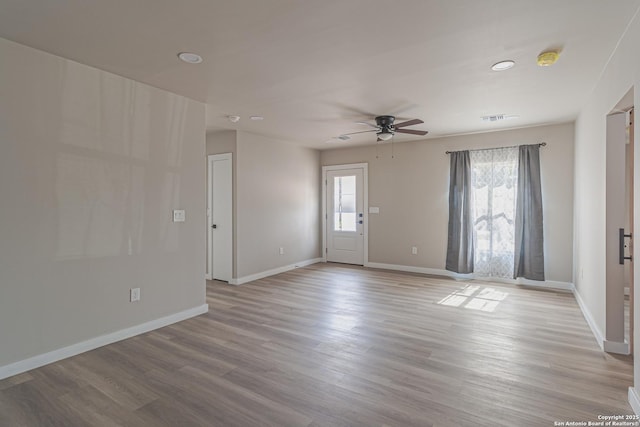 unfurnished room featuring ceiling fan and light hardwood / wood-style flooring