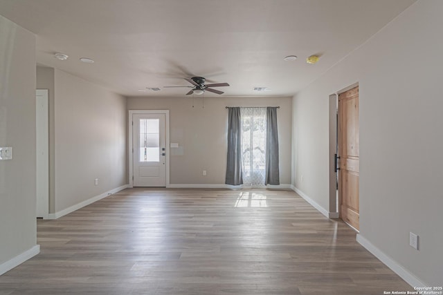 entrance foyer with ceiling fan and light wood-type flooring