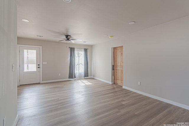 empty room featuring ceiling fan and light hardwood / wood-style flooring