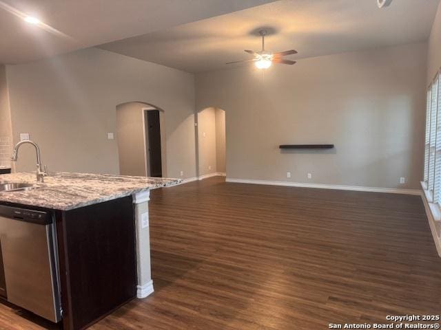 unfurnished living room with ceiling fan, dark hardwood / wood-style flooring, and sink