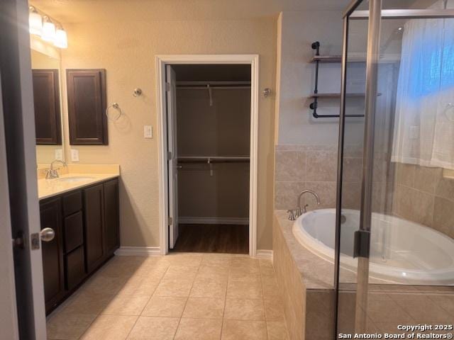 bathroom with tile patterned floors, vanity, and separate shower and tub