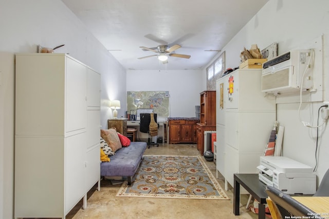 living area featuring a wall unit AC and ceiling fan