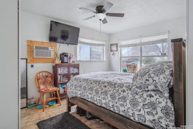 bedroom with ceiling fan and a wall mounted air conditioner