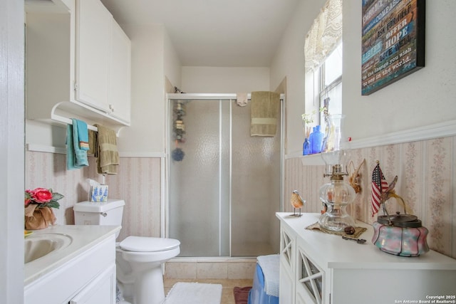 bathroom featuring walk in shower, tile patterned floors, vanity, and toilet