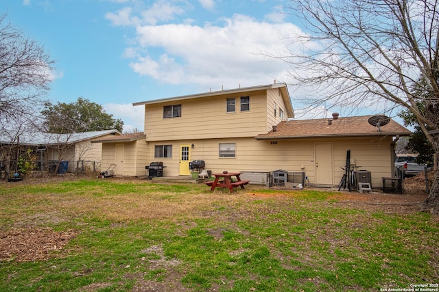 back of house with a lawn