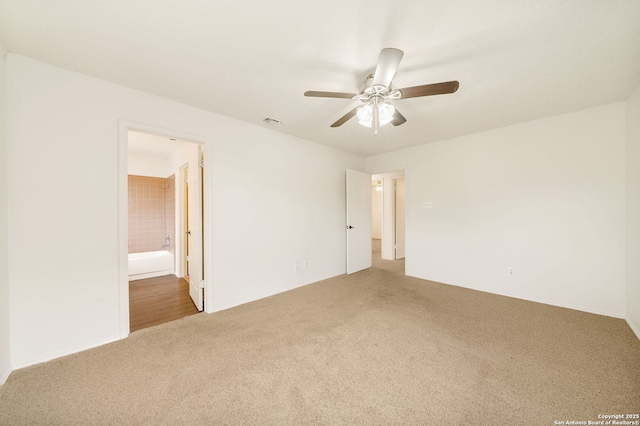 spare room with carpet floors and ceiling fan