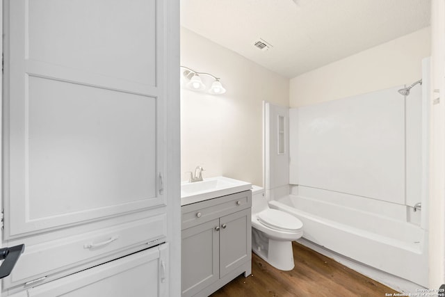 full bathroom featuring shower / tub combination, vanity, wood-type flooring, and toilet