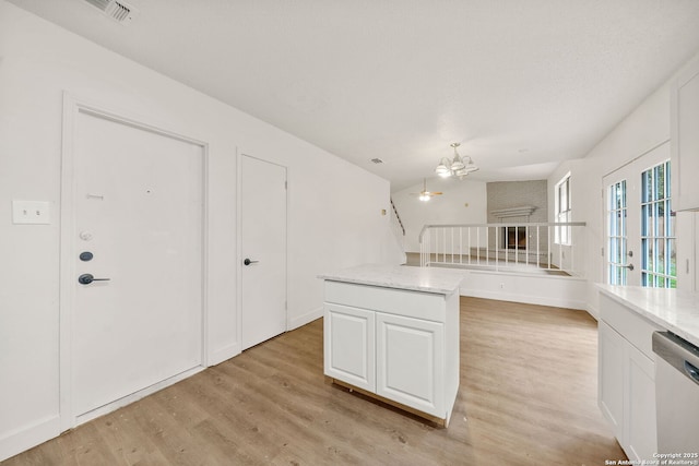 kitchen featuring white cabinetry, light hardwood / wood-style flooring, dishwasher, and a kitchen island