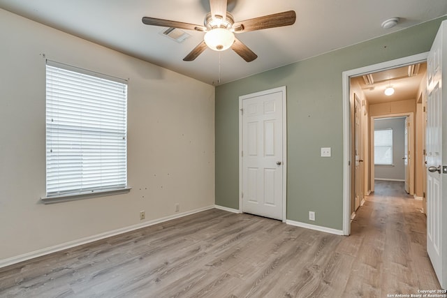 unfurnished bedroom featuring ceiling fan and light wood-type flooring