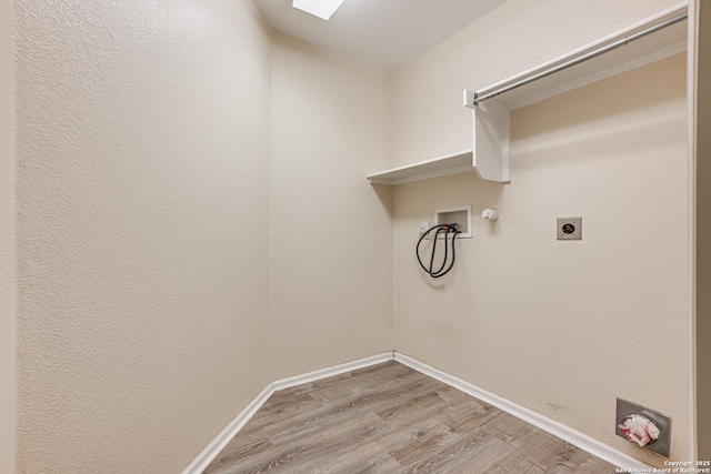 washroom featuring hookup for a washing machine, electric dryer hookup, light wood-type flooring, and hookup for a gas dryer