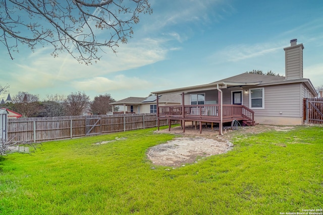 rear view of property featuring a yard and a deck