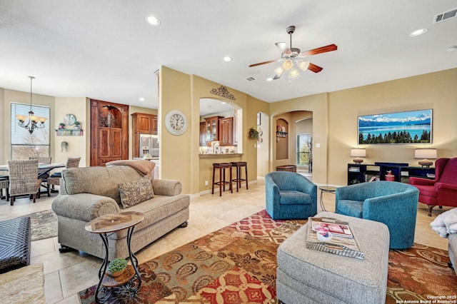 9014 Woodland Pass, Boerne, TX 78006 - living room featuring arched walkways, ceiling fan, visible vents, and plenty of natural light
