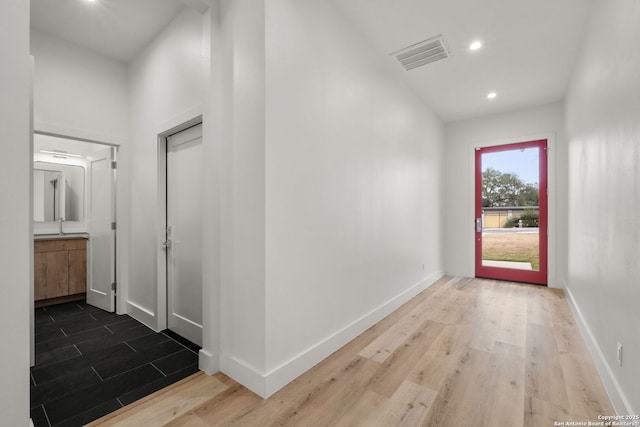 hall with hardwood / wood-style flooring