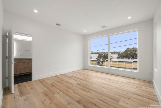 interior space featuring connected bathroom and light hardwood / wood-style flooring