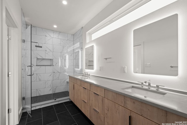 bathroom featuring vanity, a shower with shower door, and tile patterned floors