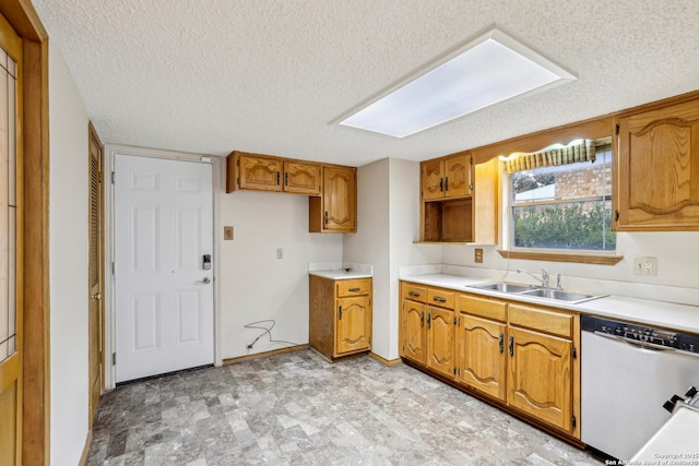 kitchen with dishwasher, sink, and a textured ceiling