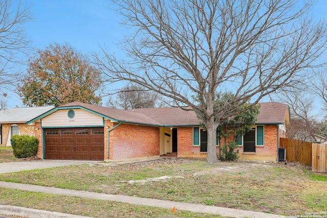 single story home featuring a garage and central air condition unit