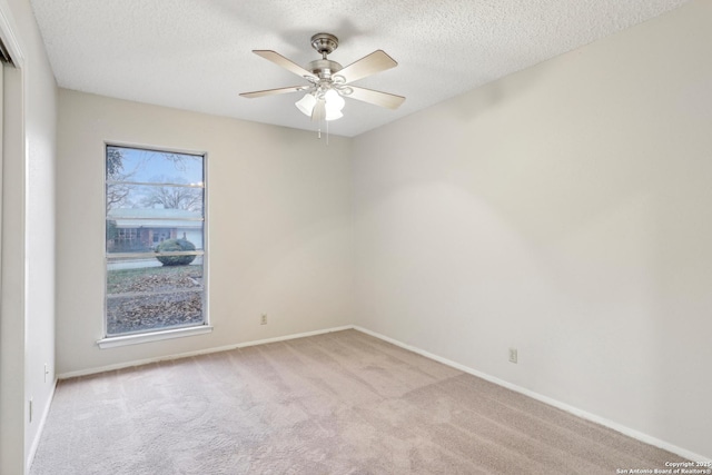 carpeted empty room featuring a textured ceiling and ceiling fan