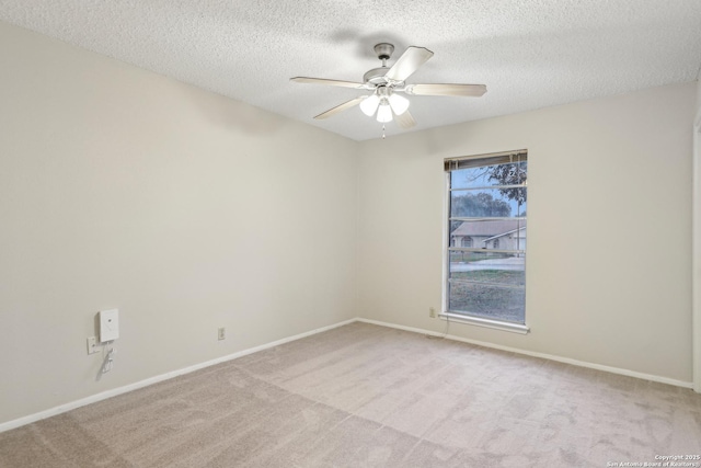 spare room with light carpet, a textured ceiling, and ceiling fan