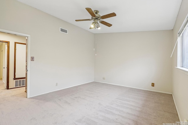 carpeted spare room with ceiling fan