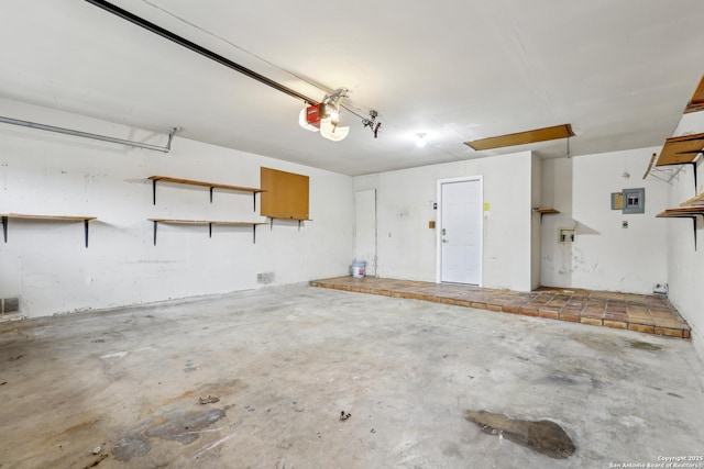 garage featuring a garage door opener and electric panel