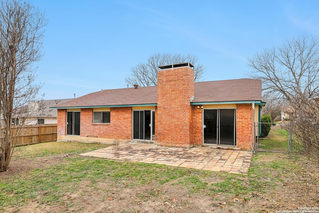 rear view of property with a yard and a patio area