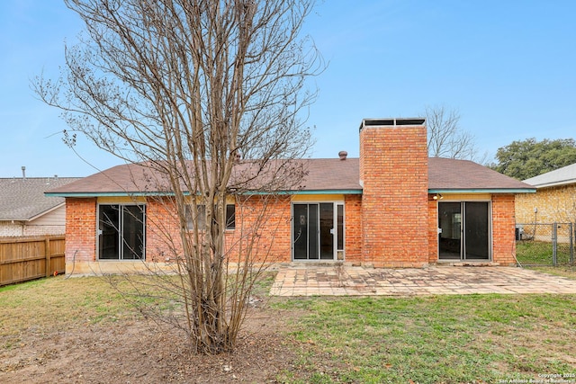 rear view of house featuring a yard and a patio area