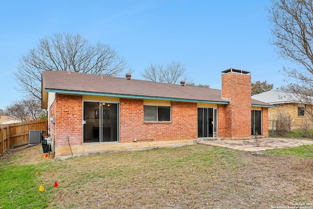 back of property featuring central AC unit, a lawn, and a patio