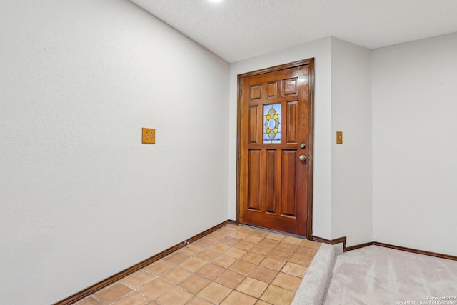 foyer entrance featuring a textured ceiling