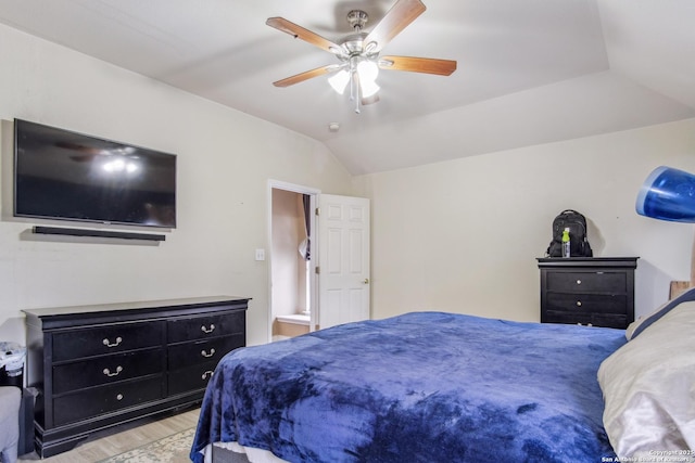 bedroom featuring vaulted ceiling, ceiling fan, and light wood-type flooring