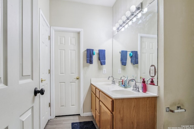 bathroom with vanity and wood-type flooring