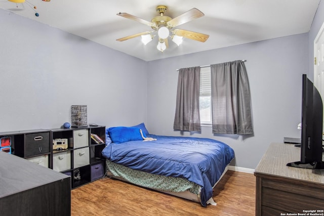 bedroom with hardwood / wood-style flooring and ceiling fan