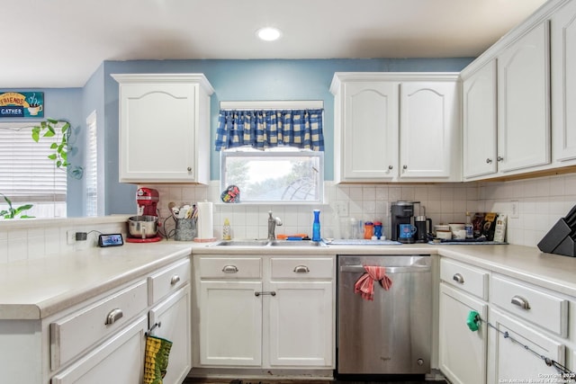 kitchen featuring white cabinetry, dishwasher, sink, and decorative backsplash