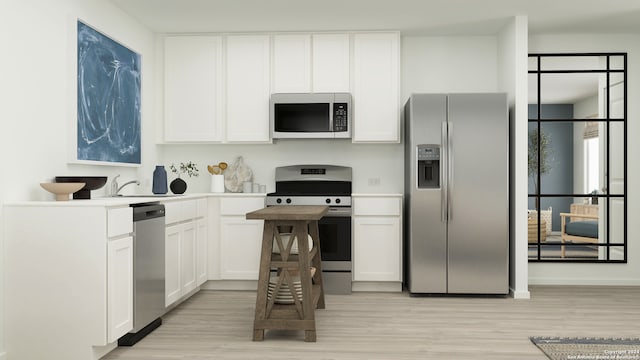 kitchen featuring light hardwood / wood-style flooring, stainless steel appliances, and white cabinets