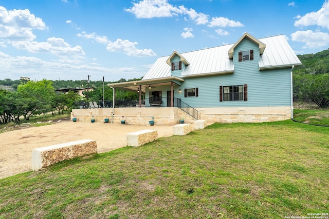 back of house featuring a yard