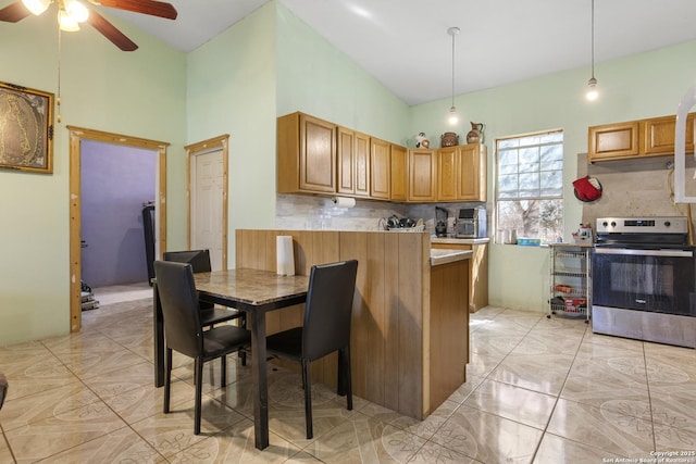 kitchen featuring stainless steel electric range oven, decorative light fixtures, kitchen peninsula, and backsplash