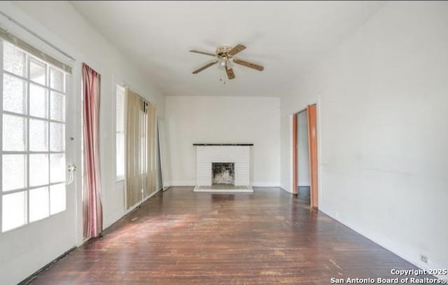 unfurnished living room with a fireplace, plenty of natural light, and wood finished floors