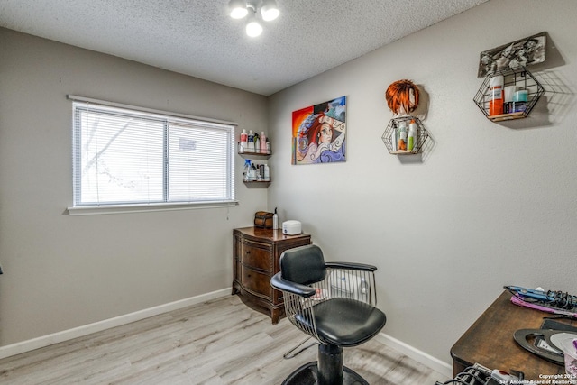 office featuring a textured ceiling and light hardwood / wood-style flooring