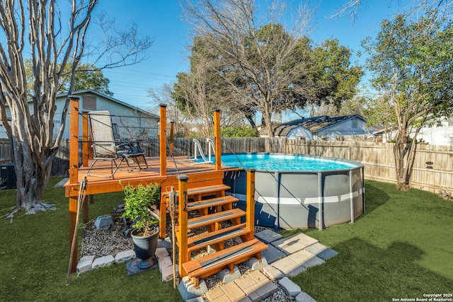 wooden terrace with a fenced in pool and a yard