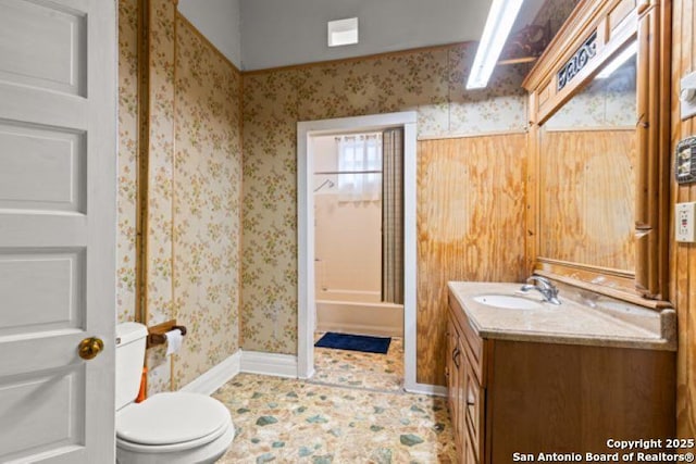 bathroom featuring walk in shower, vanity, and toilet