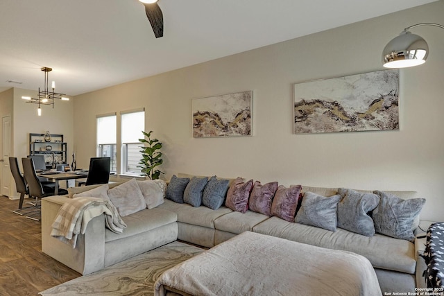 living room featuring an inviting chandelier and wood-type flooring