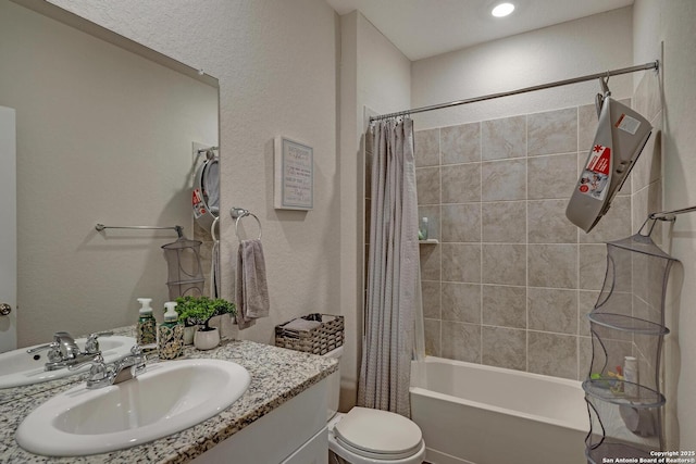 full bathroom featuring vanity, shower / bathtub combination with curtain, and toilet