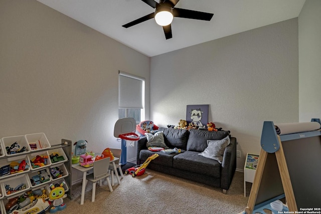 playroom with ceiling fan and carpet