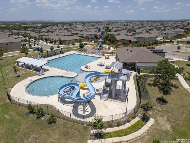 view of swimming pool featuring a water slide and a playground