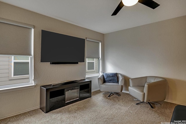 sitting room featuring light carpet and ceiling fan