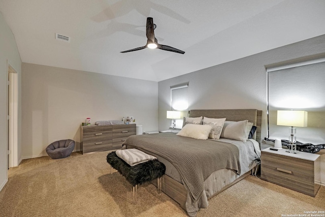 bedroom featuring light carpet, vaulted ceiling, and ceiling fan