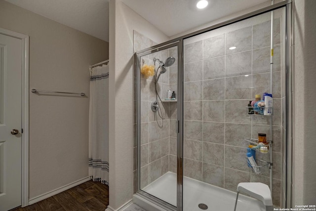 bathroom featuring tiled shower and wood-type flooring