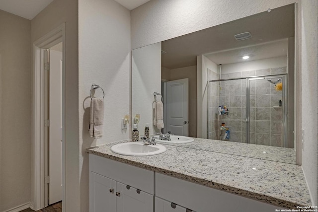 bathroom featuring vanity and an enclosed shower