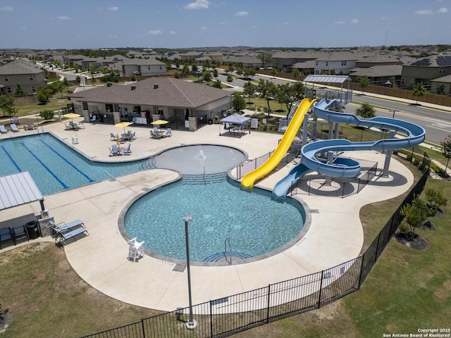 view of swimming pool with a patio and a water slide